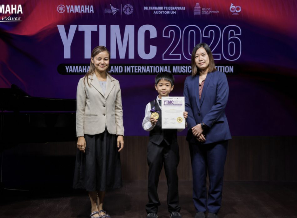 Student receiving an award on stage at the Yamaha music competition