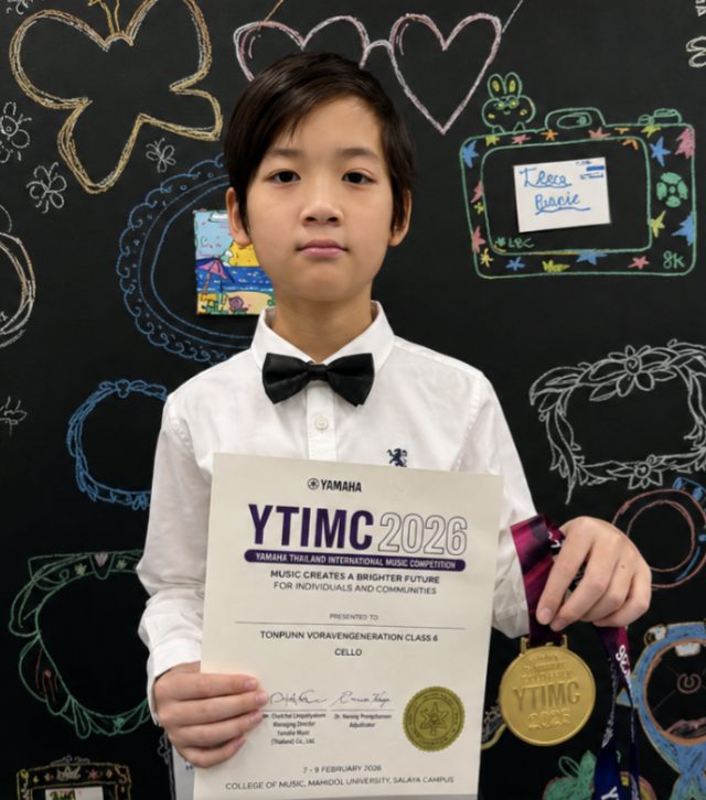 Student holding a YTIMC 2026 certificate and medal